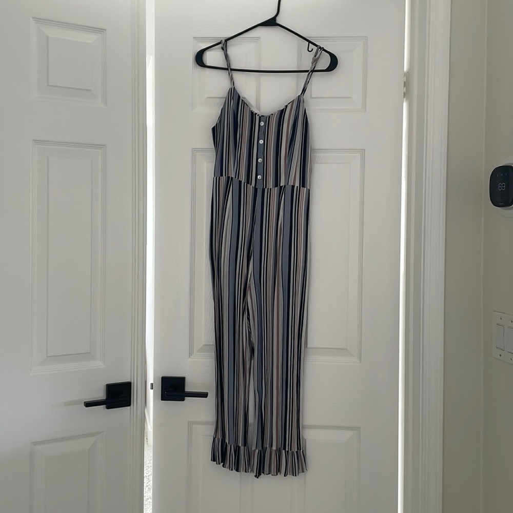 Gorgeous Everly jumpsuit. Spaghetti strap striped with a zipper in the back.